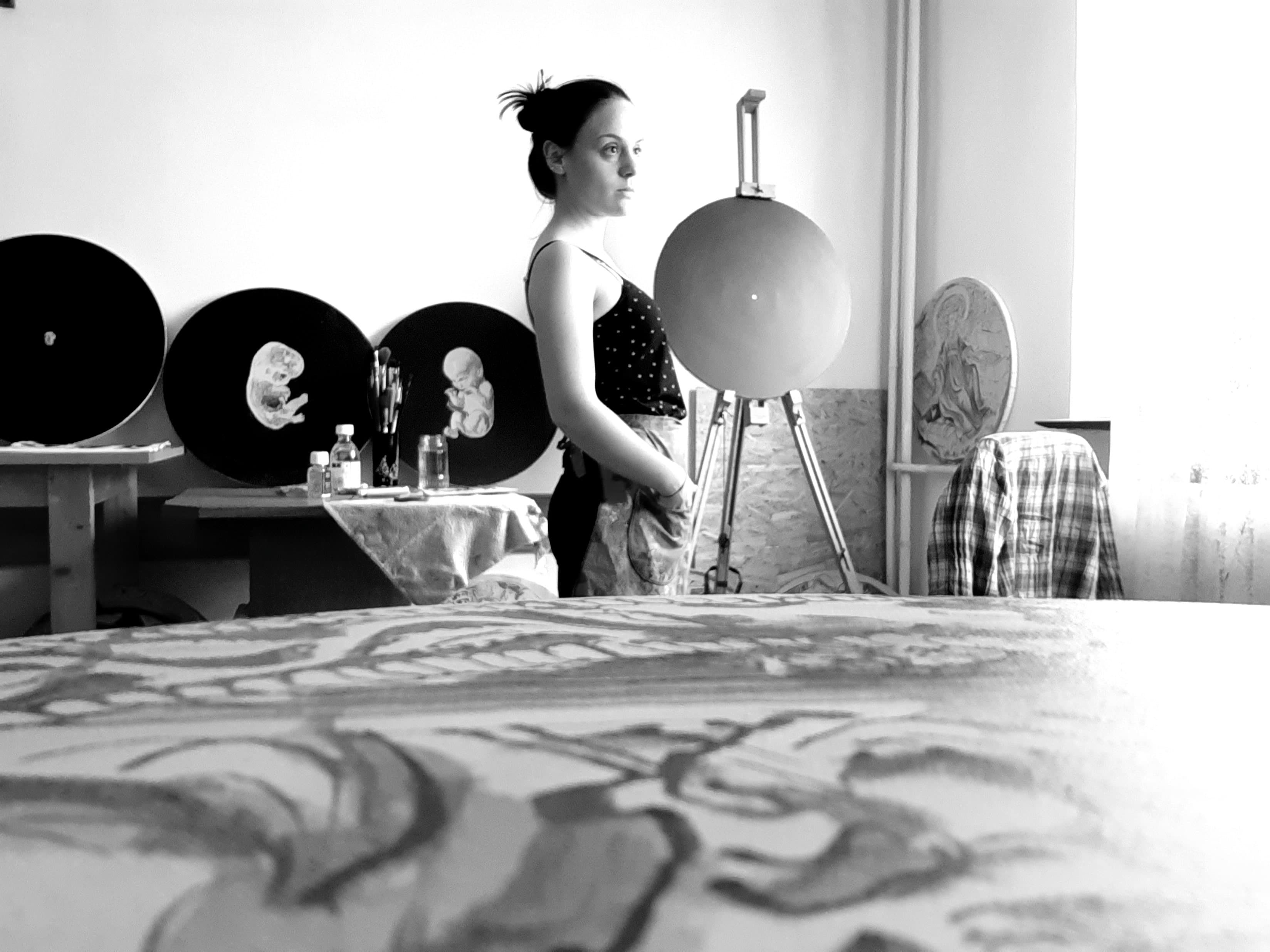 Ioana in her studio with her artwork